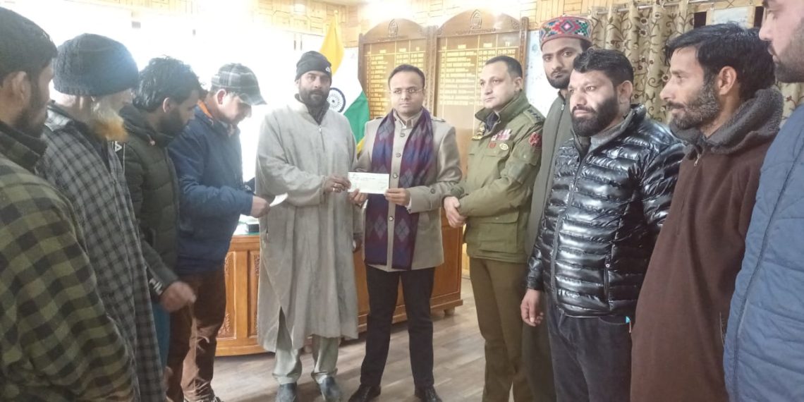 DC Kupwara hands over cheques to fire victims of Kalaroos