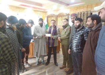 DC Kupwara hands over cheques to fire victims of Kalaroos