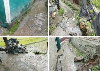 People Suffer as Water Flows on  Footpath Near the SDM Residence in Karnah 