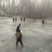 Children turn frozen pond into Cricket pitch in Sopore